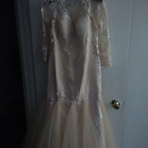 A beautiful cream color sheer top wedding dress